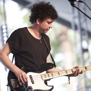 Curly-haired Bassist on Stage