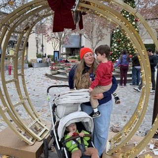 Family Holiday Moment Through Festive Golden Archway