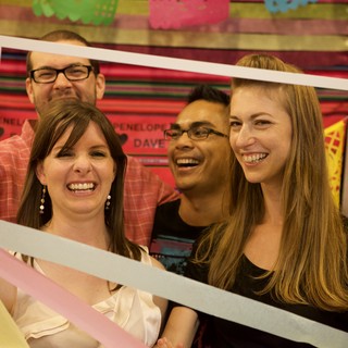 Friends Laugh Through a Giant Photo Frame