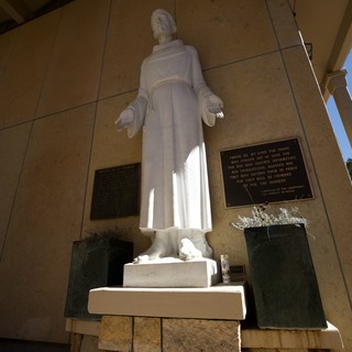 White Marble Statue of St. Francis in Stone Alcove