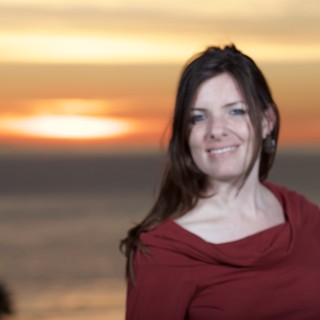Smiling Woman Glowing in Seaside Sunset Light