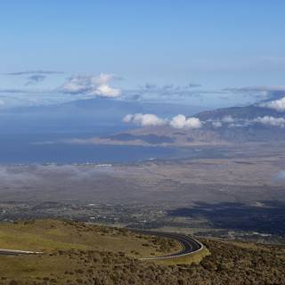 Aerial View of Maui's Scenic Road with Majestic Mountain Ranges