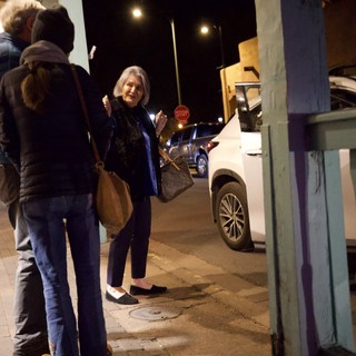 Evening Street Scene with Woman on Urban Sidewalk