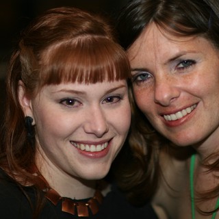 Two Smiling Women Share a Joyful Moment Together