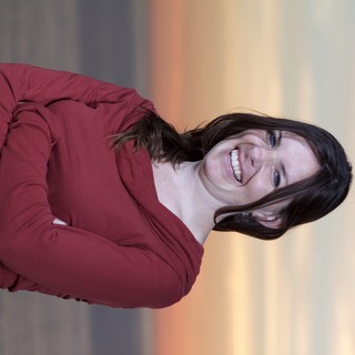 Joyful Woman Laughing at Sunset by the Sea