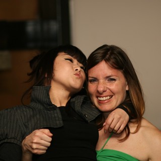 Two Friends Laugh and Pose at a Party