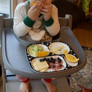 Toddler Enjoying Healthy Snack Time in High Chair
