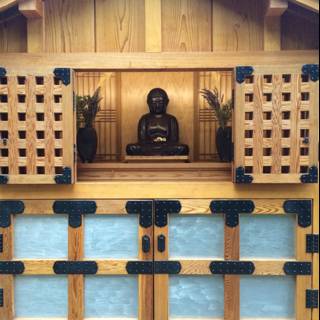 Buddha Statue Sitting on Wooden Door