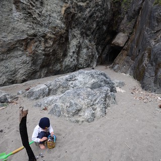 Young Explorer Collecting Treasures at Sea Cave Beach