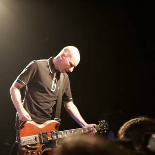 Bald Man Rocks Out on Guitar