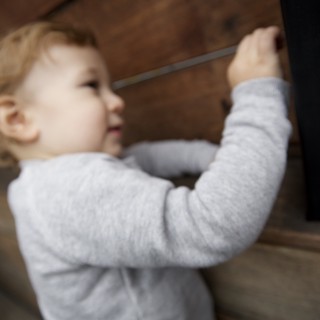 Toddler Reaching Up Indoor Wooden Staircase