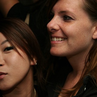 Two Women Sharing a Candid Moment at Night Event