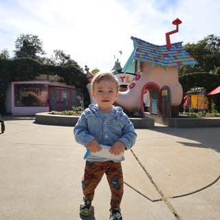 Joyful Toddler at Whimsical Shoe House Attraction
