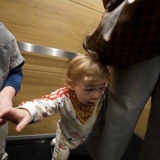 Toddler Reaching Out in Modern Elevator