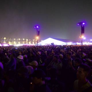 Euphoric Night at Coachella 2024: A Sea of Faces Under Purple Hues