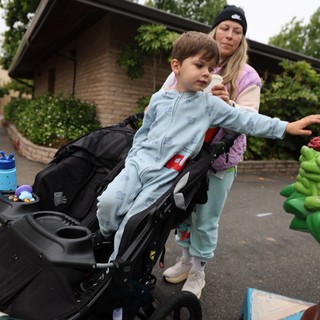 Young Boy Reaches Out at Balloon Festival