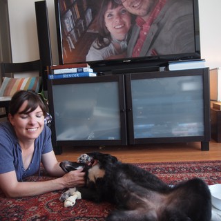 Woman Playing with Dog on Living Room Floor