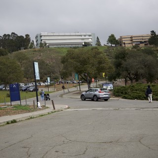 Modern University Campus on Hillside Under Overcast Sky