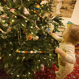 Toddler Decorating Christmas Tree with Handmade Ornaments