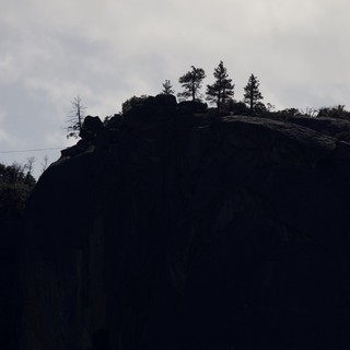 Silhouetted Rocky Outcrop with Pine Trees at Dusk
