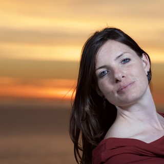Woman in Red Against a Golden Sunset Sky