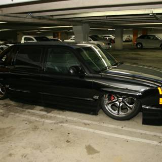 Alloy Wheels on a Black Truck in a Parking Garage