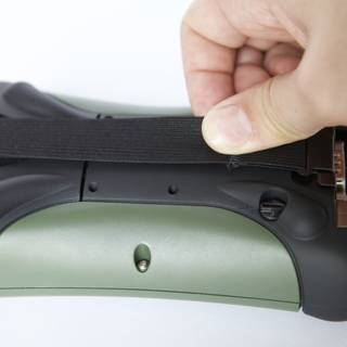 Hand holding electronic pistol strap