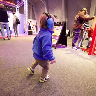Child with Headphones at Interactive Museum Exhibit