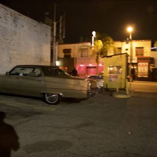 Nighttime Coupe Parked in Front of Building