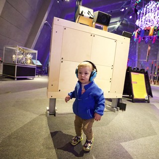 Young Child Exploring Interactive Museum Exhibit