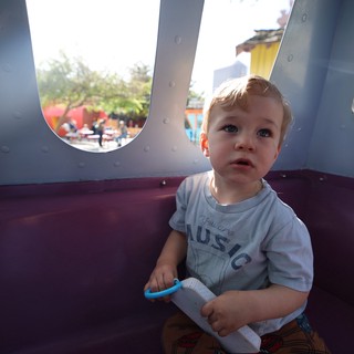 Toddler Playing in Carnival Ride at Fantasyland