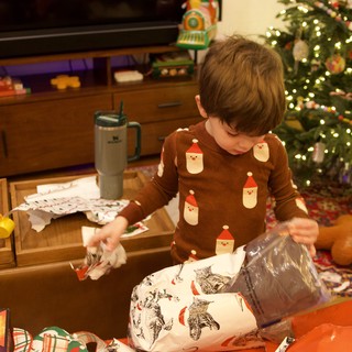 Child Opening Christmas Presents on Christmas Morning