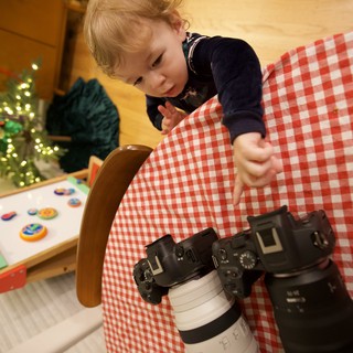 Young Child Exploring Professional Camera Equipment