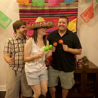 Friends Celebrate with Sombrero and Maracas at Fiesta