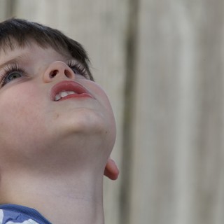 Child Looking Up in Wonder and Curiosity