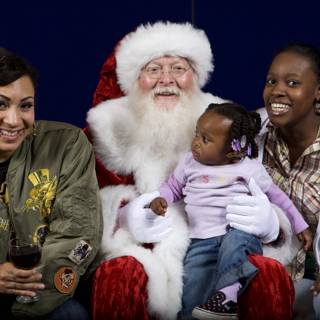 Santa Claus Spreading Christmas Cheer with Women and Child