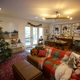 Cozy Christmas Living Room with Decorated Tree and Vintage Posters