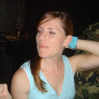 Woman with Black Eye at Nighttime Social Gathering