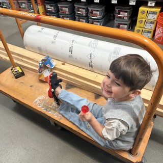 Young Child Playing in Hardware Store Shopping Cart