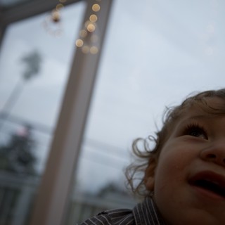 Child's Wonder: Looking Up at Holiday Lights