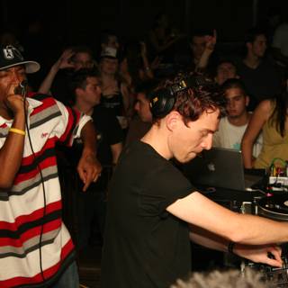 Nightclub DJ in Black Shirt with Hat and Headphones