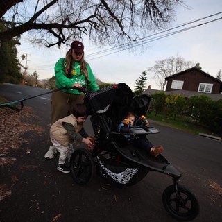 Mother with Children on Evening Neighborhood Stroller Walk