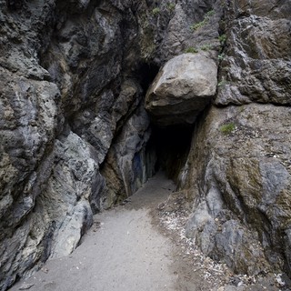 Dark Passage Through Ancient Sea Cave Entrance