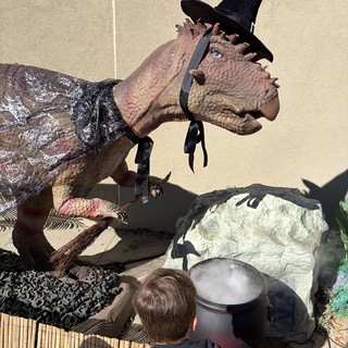 Child Encounters Life-Size Witch Dinosaur Halloween Display