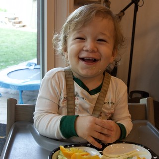 Joyful Toddler at Mealtime on Christmas Eve
