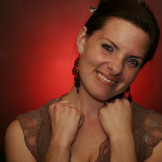 Smiling Woman in Red Light Portrait Session
