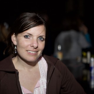 Smiling Woman at Dimly Lit Evening Venue