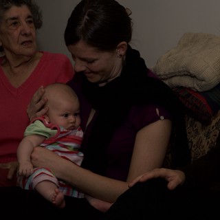 Three Generations Share a Tender Indoor Moment