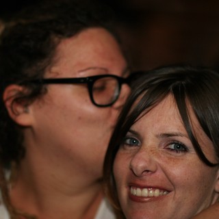Affectionate Moment Between Two Women at Social Gathering