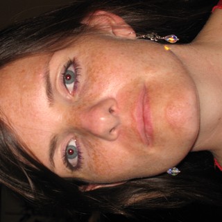 Freckled Woman in Red at Evening Gathering